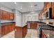 Cozy kitchen featuring stainless steel appliances, granite counters, and wood cabinets at 8409 Insignia Ave # 102, Las Vegas, NV 89178