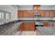 Featuring dark granite countertops and stainless steel appliances at 8409 Insignia Ave # 102, Las Vegas, NV 89178
