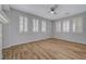 Airy living room with lots of windows, wood floors, and modern ceiling fan at 8409 Insignia Ave # 102, Las Vegas, NV 89178
