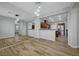 Spacious living room showcases an accent mirror wall and wood-look tile flooring at 8409 Insignia Ave # 102, Las Vegas, NV 89178
