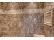 Close-up of the tiled shower with decorative band and built-in niche at 8409 Insignia Ave # 102, Las Vegas, NV 89178