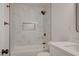 Bathroom featuring sleek, modern tile, a bathtub, and a shower combination at 8412 Mulcahy Ave, Las Vegas, NV 89145