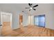 Spacious bedroom featuring a ceiling fan, wood-look flooring, and a sliding glass door to the backyard at 8412 Mulcahy Ave, Las Vegas, NV 89145