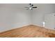 Bright, spacious bedroom with wood-look flooring, ceiling fan, and white door at 8412 Mulcahy Ave, Las Vegas, NV 89145