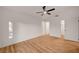 Large bedroom with wood-look flooring and two doors leading to closet and bathroom at 8412 Mulcahy Ave, Las Vegas, NV 89145