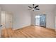 Light-filled bedroom featuring wood-look flooring, white walls, and sliding glass doors to the backyard at 8412 Mulcahy Ave, Las Vegas, NV 89145