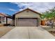 Home's exterior showcasing the garage, driveway, and well-maintained landscaping at 8412 Mulcahy Ave, Las Vegas, NV 89145
