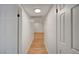 Bright hallway with wood-look flooring and white walls that provides a clean and modern feel at 8412 Mulcahy Ave, Las Vegas, NV 89145