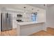 Modern kitchen with stainless steel appliances, white cabinets, stylish pendant lights, and quartz counters at 8412 Mulcahy Ave, Las Vegas, NV 89145