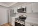 Close-up of updated kitchen, stainless steel appliances, white cabinets, and modern hardware accents at 8412 Mulcahy Ave, Las Vegas, NV 89145