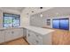 Kitchen with quartz counters and luxury vinyl plank flooring, open to the dining and living areas at 8412 Mulcahy Ave, Las Vegas, NV 89145