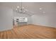 Spacious living room with hardwood flooring and an open view to the kitchen at 8412 Mulcahy Ave, Las Vegas, NV 89145