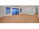 Bright living room featuring wood flooring and large sliding glass doors leading to the patio at 8412 Mulcahy Ave, Las Vegas, NV 89145