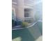 View of the outside space with air conditioning units, green artificial turf, and bushes at 8805 Jeffreys St # 1112, Las Vegas, NV 89123