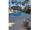 Community pool with lounge chairs, palm trees, and building views at 8805 Jeffreys St # 1112, Las Vegas, NV 89123