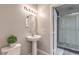 Bathroom features a sleek pedestal sink, modern fixtures, and walk-in shower access at 91 E Agate Ave # 204, Las Vegas, NV 89123