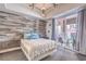 Modern bedroom features a decorative wood wall, plush bedding and sliding doors to a balcony at 91 E Agate Ave # 204, Las Vegas, NV 89123