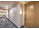 A well-maintained hallway with carpeting leads to unit, with wall lighting, and neutral decor at 91 E Agate Ave # 204, Las Vegas, NV 89123