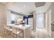 Modern kitchen with white countertops, breakfast bar seating, and stainless steel appliances at 91 E Agate Ave # 204, Las Vegas, NV 89123