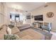 Comfortable living area featuring a large sectional sofa and open flow to the kitchen at 91 E Agate Ave # 204, Las Vegas, NV 89123