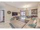 Inviting living room with a plush sectional sofa, TV, and sliding door to outdoor area at 91 E Agate Ave # 204, Las Vegas, NV 89123