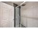 Modern walk-in shower features subway tile surround and a black and white tile floor at 91 E Agate Ave # 204, Las Vegas, NV 89123