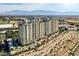 An aerial shot features the high-rise condo building set against a backdrop of scenic mountain views at 9101 Alta Dr # 507, Las Vegas, NV 89145