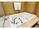 Close-up of a soaking bathtub with luxurious fixtures and decorative marble accents around the tub at 9101 Alta Dr # 507, Las Vegas, NV 89145