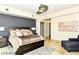 Comfortable bedroom with a modern ceiling fan, a large headboard, and decorative pillows on the bed at 9101 Alta Dr # 507, Las Vegas, NV 89145