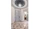 Elegant foyer features marble floors, custom lighting, and a statement chandelier at 9101 Alta Dr # 507, Las Vegas, NV 89145