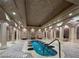 A luxurious indoor pool is situated beneath an ornate ceiling and surrounded by pillars and arched doorways at 9101 Alta Dr # 507, Las Vegas, NV 89145