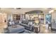 Spacious living room with modern grey furniture, large windows, and an open kitchen and dining area at 9101 Alta Dr # 507, Las Vegas, NV 89145