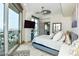 Main bedroom with large windows, balcony and modern ceiling fan at 9101 Alta Dr # 507, Las Vegas, NV 89145