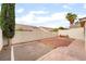 Backyard view with low-maintenance gravel landscaping, hardscape area, and privacy wall at 9289 Mandeville Bay Ave, Las Vegas, NV 89148