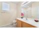 Bathroom with toilet, single sink vanity, and bathtub with shower at 9289 Mandeville Bay Ave, Las Vegas, NV 89148