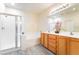 The main bath features double sinks, tile floors, and a glass-enclosed shower and tub at 9289 Mandeville Bay Ave, Las Vegas, NV 89148