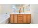 Bathroom with a double sink vanity and tub shower combo at 9289 Mandeville Bay Ave, Las Vegas, NV 89148