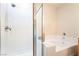Bathroom featuring a shower with white tiling and a clear shower door next to the bathtub at 9289 Mandeville Bay Ave, Las Vegas, NV 89148