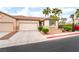 Charming home with a two-car garage, desert landscaping, and a well-maintained yard offers excellent curb appeal at 9289 Mandeville Bay Ave, Las Vegas, NV 89148