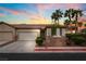 Charming single-story home with a well-maintained front yard and a two-car garage and palm trees at 9289 Mandeville Bay Ave, Las Vegas, NV 89148