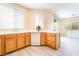 Updated kitchen with wood cabinets, tile floors and countertops, and stainless steel appliances at 9289 Mandeville Bay Ave, Las Vegas, NV 89148