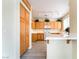 Updated kitchen featuring wood cabinets, tile floors, white appliances, and bright lighting at 9289 Mandeville Bay Ave, Las Vegas, NV 89148