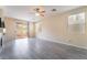 Spacious living room with a ceiling fan, tile floors, and slider doors to the backyard at 9289 Mandeville Bay Ave, Las Vegas, NV 89148