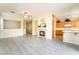 Open-concept living space with a fireplace, tile floors, and adjacent kitchen area at 9289 Mandeville Bay Ave, Las Vegas, NV 89148