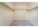 Spacious walk-in closet featuring gray flooring and metal racks and shelving at 9289 Mandeville Bay Ave, Las Vegas, NV 89148