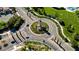 Aerial shot of neighborhood roundabout with sidewalks and lush landscaping at 936 Viscanio Pl, Las Vegas, NV 89138