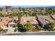 Aerial view of community homes with lush landscaping, with city skyline in background at 936 Viscanio Pl, Las Vegas, NV 89138