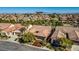 Aerial view of community homes with lush landscaping, with city skyline in background at 936 Viscanio Pl, Las Vegas, NV 89138