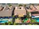 Aerial view of backyard pool and outdoor patio, with neighboring rooftops at 936 Viscanio Pl, Las Vegas, NV 89138