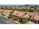 Aerial view of community homes with lush landscaping, with city skyline in background at 936 Viscanio Pl, Las Vegas, NV 89138